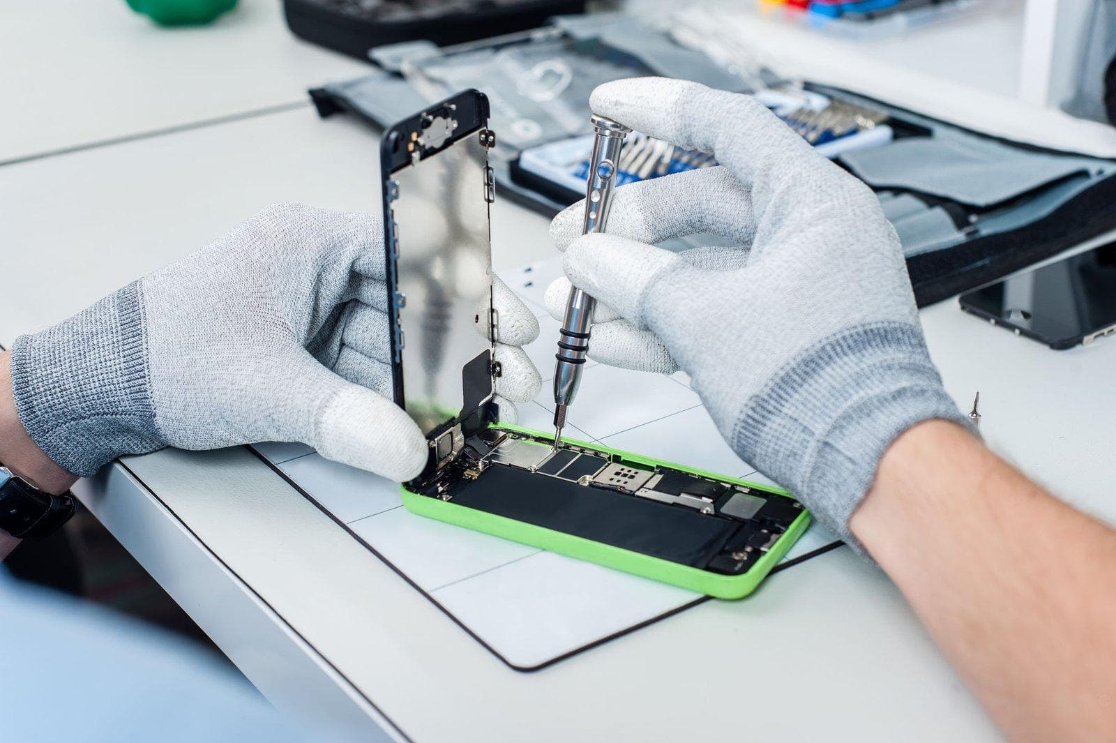 Technician repairing a smartphone at iFIX Service Centre